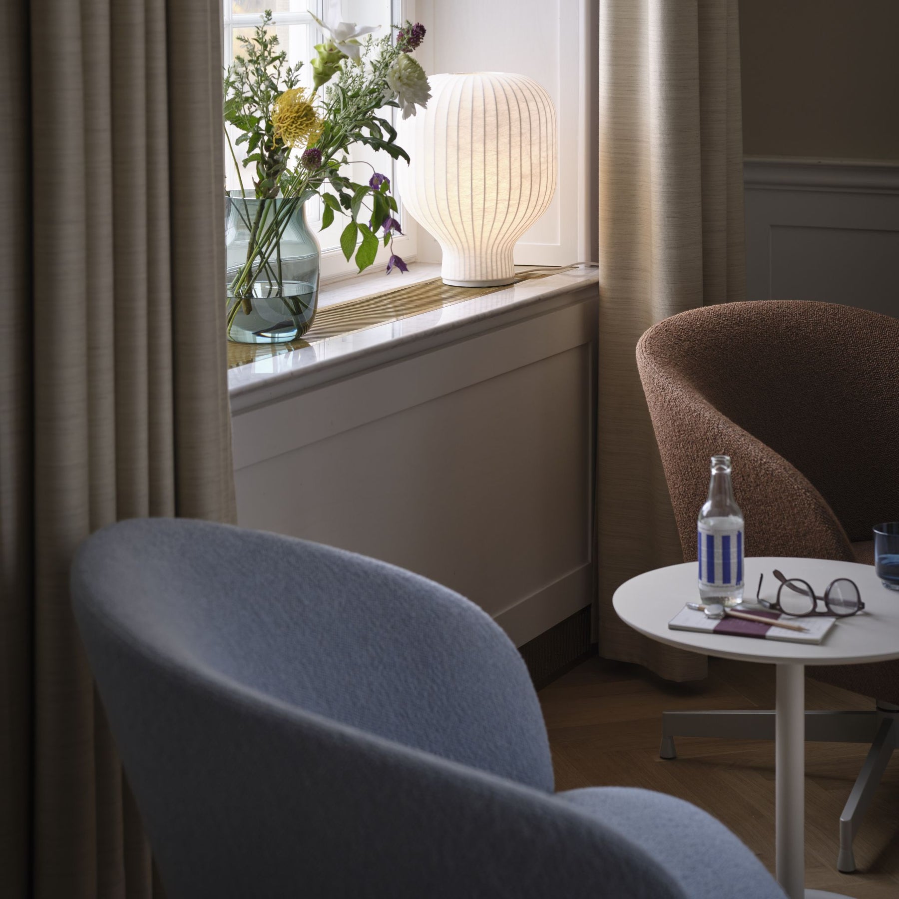 Muuto Soft Side Table Off White in Reading Room with Oslo Swivel Chairs and Strand Table Lamp