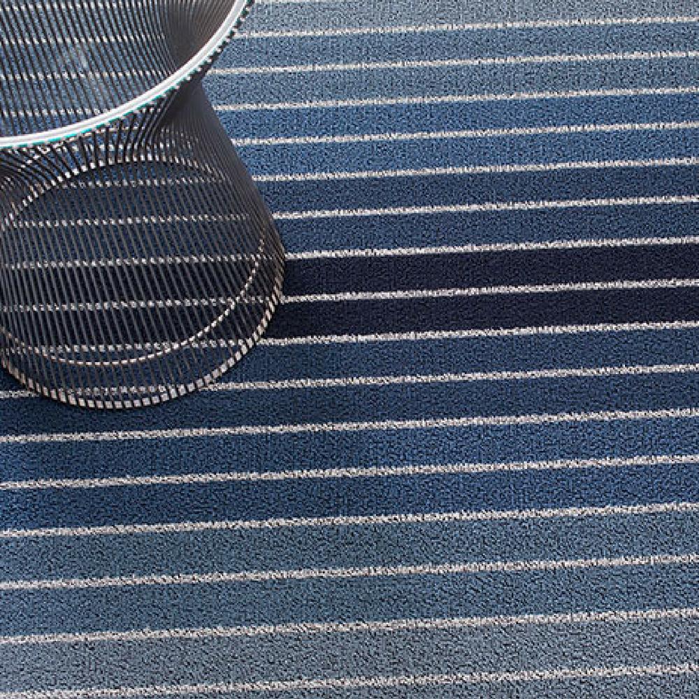 https://www.paletteandparlor.com/cdn/shop/products/chilewich-bold-stripe-indoor-outdoor-shag-mat-denim-with-knoll-platner-side-table.jpg?v=1595797004