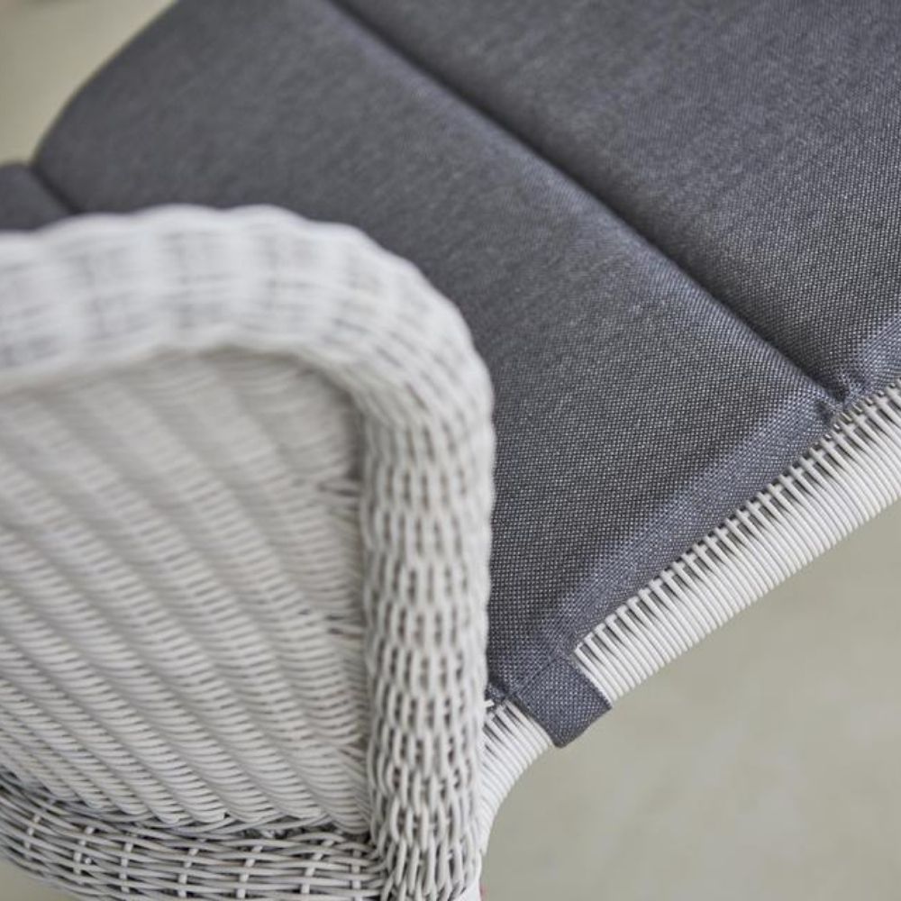 https://www.paletteandparlor.com/cdn/shop/products/lean-chair-white-grey-cane-line-weave-with-grey-natte-sunbrella-cushion-stackable-welling-ludvik-closeup-cane-line.jpg?v=1642605546