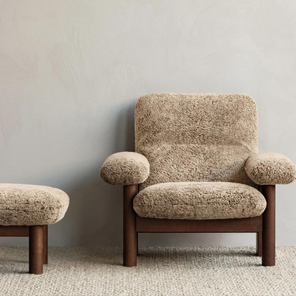 https://www.paletteandparlor.com/cdn/shop/products/menu-brasilia-sheepskin-lounge-chair-and-ottoman-with-gravel-rug.jpg?v=1679856380